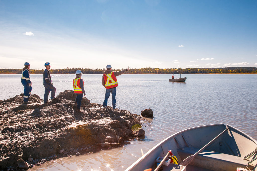 BarCan feed pond. T Hefford – Labourer from Exploits Welding and Machine Shop, C Savoie –Skilled  Labourer from Exploits Welding and Machine Shop, T Pinsent – HR, Safety Programs and Operations Administrator , R Brace –Operational Safety and Maintenance Manager
Boat Operator – C Stuckless – Welder from Exploits Welding and Machine Shop, redirecting the Tails line