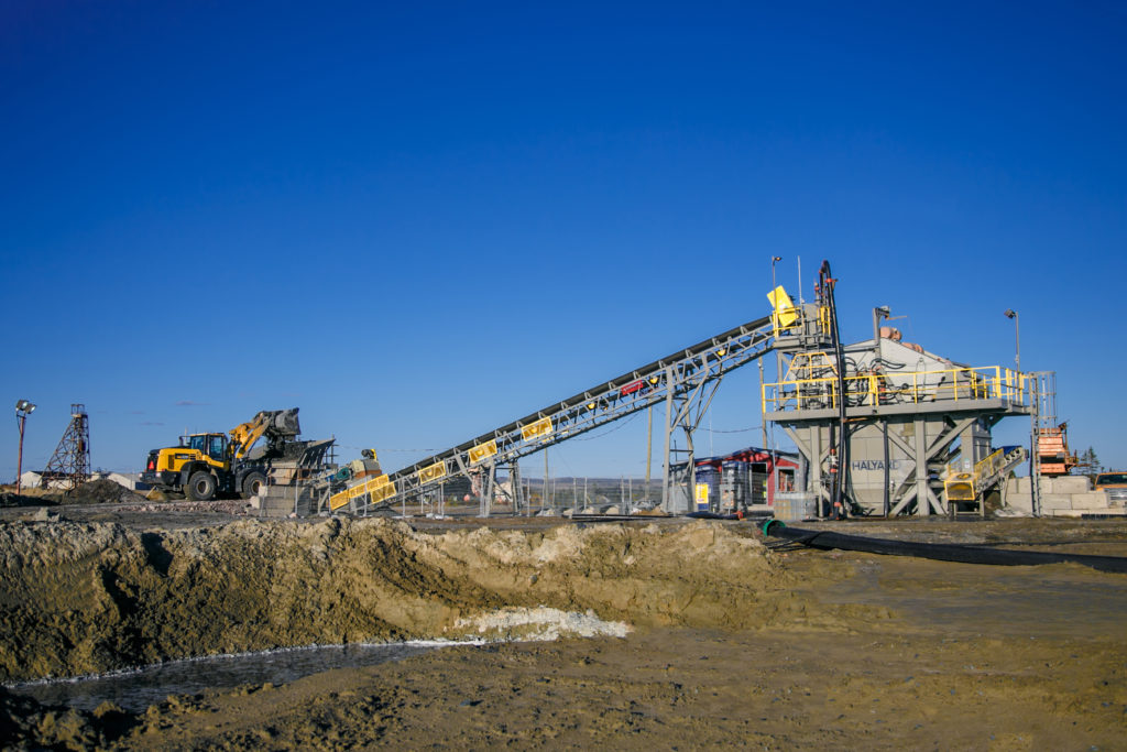 On the BarCan mine site - Loader Operator is loading the Hopper with dry feed that will travel up the conveyor and into the Kwatani