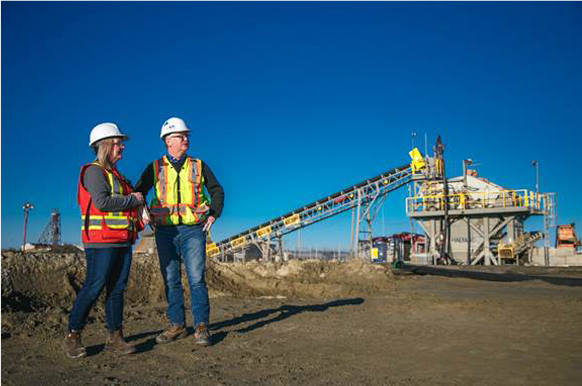 Tammy Pinsent, Human Resources, BMSI Safety Programs and Operations Administrator and Mike Rose, BMSI CEO observing the mining process, Kwatani in the background