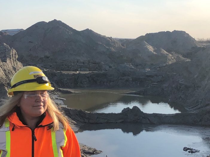 Gordana Slepcev, BarCan Chief Operating Officer in front of tailings on Buchans mill site.