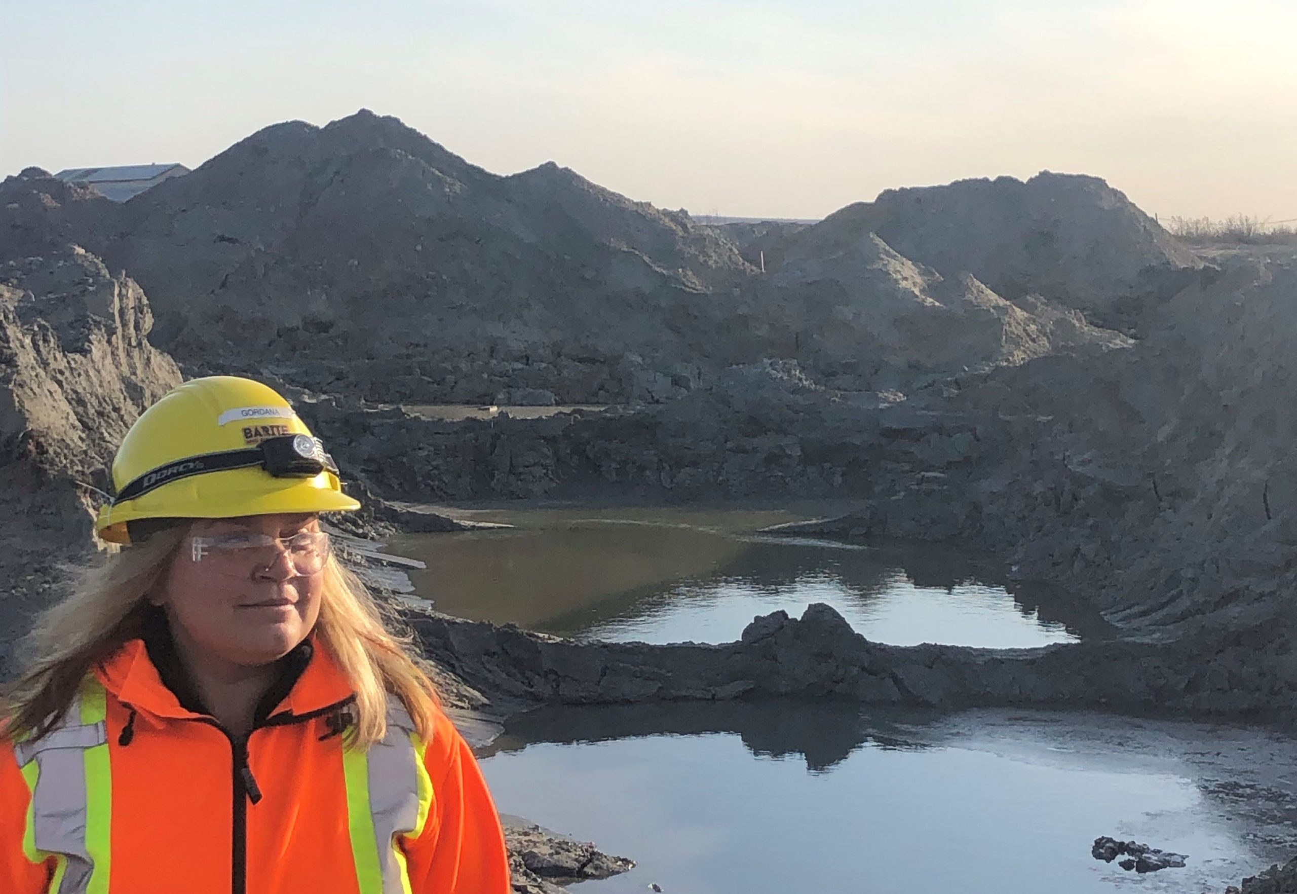 Gordana Slepcev, BarCan Chief Operating Officer in front of tailings on Buchans mill site.